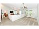 Spacious living room with plush carpet, a ceiling fan, and patio access at 10306 Tybalt Dr, Fishers, IN 46038