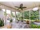Screened patio featuring a ceiling fan and a view of the backyard with lots of plants and outdoor seating at 10306 Tybalt Dr, Fishers, IN 46038