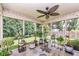 Sunroom with plants, ceiling fan and lighting, overlooking a lush green lawn with mature trees at 10306 Tybalt Dr, Fishers, IN 46038