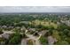 Extensive greenery surrounds a home in an aerial view, showcasing the neighborhood at 10455 Trewithen Ln, Carmel, IN 46032