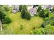 Expansive lawn surrounds this traditional home with mature trees and manicured landscaping at 10455 Trewithen Ln, Carmel, IN 46032