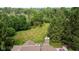 Aerial view of a spacious backyard with lush lawn and mature trees at 10455 Trewithen Ln, Carmel, IN 46032