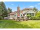Spacious backyard featuring a deck, a chimney and lovely garden with various plants and flowers at 10455 Trewithen Ln, Carmel, IN 46032
