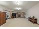 Spacious finished basement area featuring a brick fireplace and various seating options at 10455 Trewithen Ln, Carmel, IN 46032