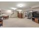Basement living space features a dining area, stairs, and an open workout area at 10455 Trewithen Ln, Carmel, IN 46032