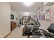 Finished basement with workout and entertainment equipment, decorated with sports-themed art at 10455 Trewithen Ln, Carmel, IN 46032