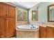 Bathroom featuring tile backsplash and a soaking tub at 10455 Trewithen Ln, Carmel, IN 46032