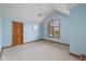 Bedroom featuring blue walls, neutral carpet and a large window for natural light at 10455 Trewithen Ln, Carmel, IN 46032