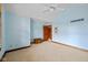 Bedroom featuring blue walls, neutral carpet, a ceiling fan, and access to other rooms at 10455 Trewithen Ln, Carmel, IN 46032