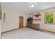 Bright bedroom featuring neutral paint, carpet, built-in storage, and a window with a leafy green view at 10455 Trewithen Ln, Carmel, IN 46032
