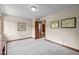 Bedroom with neutral carpet and trim with access to other rooms at 10455 Trewithen Ln, Carmel, IN 46032