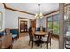 Dining room featuring stylish furniture, crown molding, and natural light at 10455 Trewithen Ln, Carmel, IN 46032
