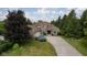 A brick house with a well-manicured lawn and a long concrete driveway at 10455 Trewithen Ln, Carmel, IN 46032