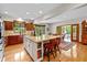 Open kitchen includes an island with seating and opens to a dining area at 10455 Trewithen Ln, Carmel, IN 46032