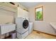 Well-organized laundry room featuring LG washer/dryer, utility sink and storage cabinets at 10455 Trewithen Ln, Carmel, IN 46032