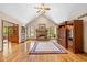 Bright living room with hardwood floors, a fireplace, and built-in shelving at 10455 Trewithen Ln, Carmel, IN 46032