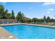 Sparkling pool with lounge chairs and privacy fencing, perfect for summer relaxation at 10455 Trewithen Ln, Carmel, IN 46032