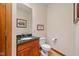 Powder room features a granite vanity and hardwood floors at 10455 Trewithen Ln, Carmel, IN 46032