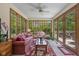 Sunroom with lots of natural light, tile floors, and views of lush backyard at 10455 Trewithen Ln, Carmel, IN 46032