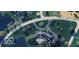 Stunning aerial view of an estate home with lush landscaping, circular drive, and lakeside setting at 1089 Laurelwood, Carmel, IN 46032