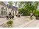 Spacious backyard showcasing a patio with dining sets, manicured landscaping, and the home's architectural design at 1089 Laurelwood, Carmel, IN 46032