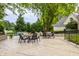 Expansive backyard featuring a pool, green landscape and a covered patio with dining set for outdoor pleasure at 1089 Laurelwood, Carmel, IN 46032