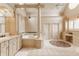 Spacious bathroom features column detail, chandelier, bathtub, and double vanity at 1089 Laurelwood, Carmel, IN 46032