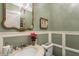 Bathroom with stylish wainscotting, a decorative chandelier, and a marble-topped vanity at 1089 Laurelwood, Carmel, IN 46032