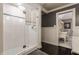 Modern bathroom featuring a glass-enclosed shower with white subway tile and dark wood flooring at 1089 Laurelwood, Carmel, IN 46032