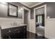 Stylish bathroom featuring a dark vanity with marble countertop and wainscoting, adjacent to bedroom at 1089 Laurelwood, Carmel, IN 46032