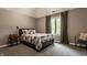 Cozy bedroom with a comfortable bed, soft carpeting, and a bright window with backyard views at 1089 Laurelwood, Carmel, IN 46032