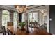 Elegant dining room features beautiful chandelier, arched windows, and hardwood table at 1089 Laurelwood, Carmel, IN 46032