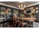 Formal dining room with hardwood floors, crown molding, stylish chandelier, and elegant decor at 1089 Laurelwood, Carmel, IN 46032