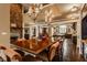 Open dining room featuring a grand stone fireplace and designer lighting at 1089 Laurelwood, Carmel, IN 46032