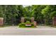 Elegant gated entrance with brick pillars, decorative wrought iron, and lush floral accents at 1089 Laurelwood, Carmel, IN 46032