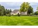 Elegant estate featuring manicured lawns, beautiful landscaping, and a grand brick facade at 1089 Laurelwood, Carmel, IN 46032