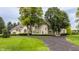 Luxury home featuring a circular driveway, manicured lawn, and stately brick architecture at 1089 Laurelwood, Carmel, IN 46032
