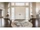 Welcoming foyer with double doors, hardwood flooring, and an elegant rug beneath the doors at 1089 Laurelwood, Carmel, IN 46032