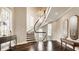 Grand foyer featuring a curved staircase, hardwood floors, chandelier, and ample natural light at 1089 Laurelwood, Carmel, IN 46032