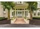 Inviting front entrance with brick steps, lush landscaping, and elegant double doors at 1089 Laurelwood, Carmel, IN 46032