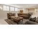 Comfortable living room with plenty of natural light, seating, and a ping pong table in the background at 1089 Laurelwood, Carmel, IN 46032