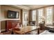 Cozy living room features hardwood floors, TV, and an abundance of natural light at 1089 Laurelwood, Carmel, IN 46032