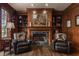 Charming living room boasts fireplace with marble, custom built-ins, and hardwood flooring at 1089 Laurelwood, Carmel, IN 46032