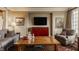 Cozy living room features hardwood floors, TV, and an abundance of natural light at 1089 Laurelwood, Carmel, IN 46032