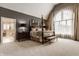 Bright main bedroom offers four poster bed, neutral decor, and ensuite access at 1089 Laurelwood, Carmel, IN 46032