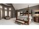 Spacious main bedroom features vaulted ceiling, four poster bed, and sitting area at 1089 Laurelwood, Carmel, IN 46032