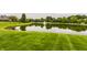 Scenic pond with a fountain and lush green lawn, offering a serene and picturesque view at 1089 Laurelwood, Carmel, IN 46032