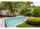 Spacious backyard with a luxurious pool, perfect for entertaining and relaxation, surrounded by green trees at 1089 Laurelwood, Carmel, IN 46032