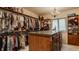 Organized walk-in closet features shelving, hanging racks, central island, and chandelier at 1089 Laurelwood, Carmel, IN 46032