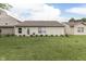 View of backyard featuring a well-maintained lawn and the rear exterior of the home at 11117 Waterfield Pl, Indianapolis, IN 46235